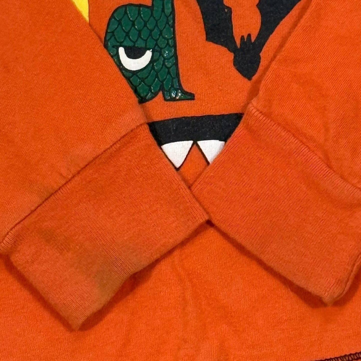 Close-up of light staining and wear on Old Navy orange Halloween shirt