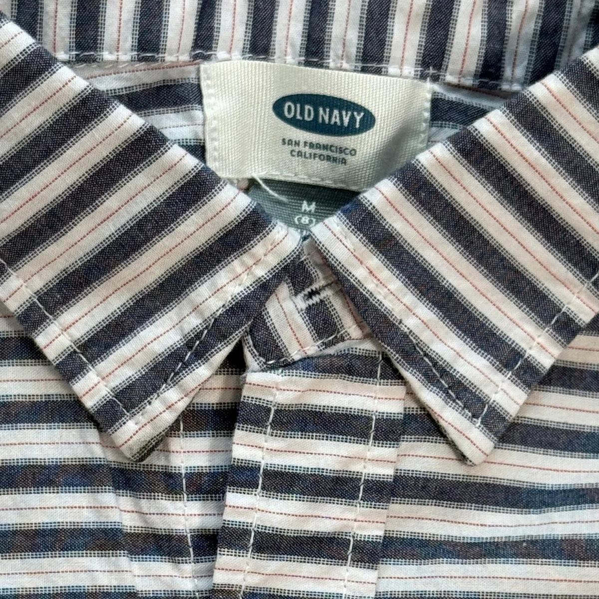 Old Navy brand label and collar detail on boys striped button-up shirt