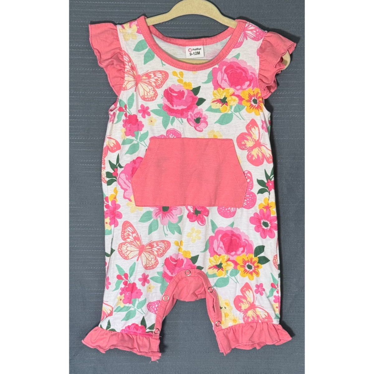 Front view of PatPat baby girls floral butterfly romper size 9–12 months with coral-pink kangaroo pocket, ruffled sleeves, and inseam snaps.