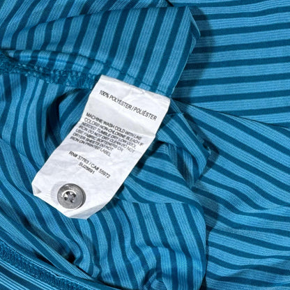 Close-up of the blue striped pattern, black collar, and button placket on the PGA TOUR performance golf polo.