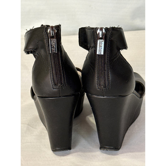 Back view of black Reaction Kenneth Cole wedge sandals showing silver zipper closures and ankle cuff wear.