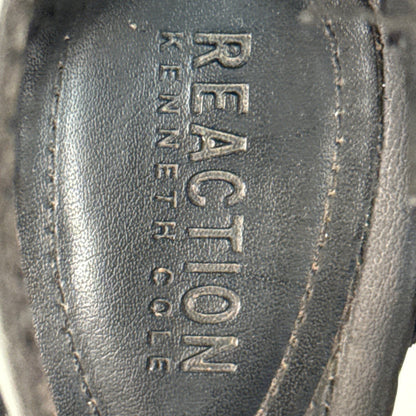 Close-up of Reaction Kenneth Cole branding on the black sandal footbed.