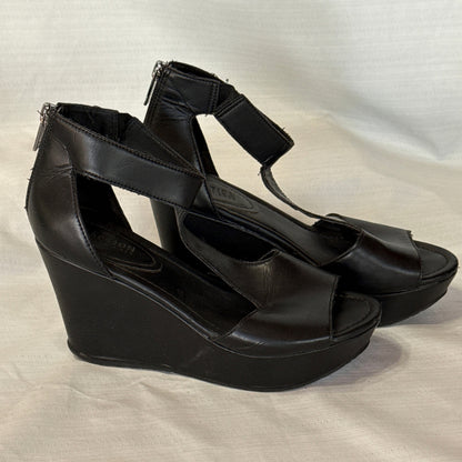 Angled side view of black Reaction Kenneth Cole wedge sandals with open toes and ankle straps.