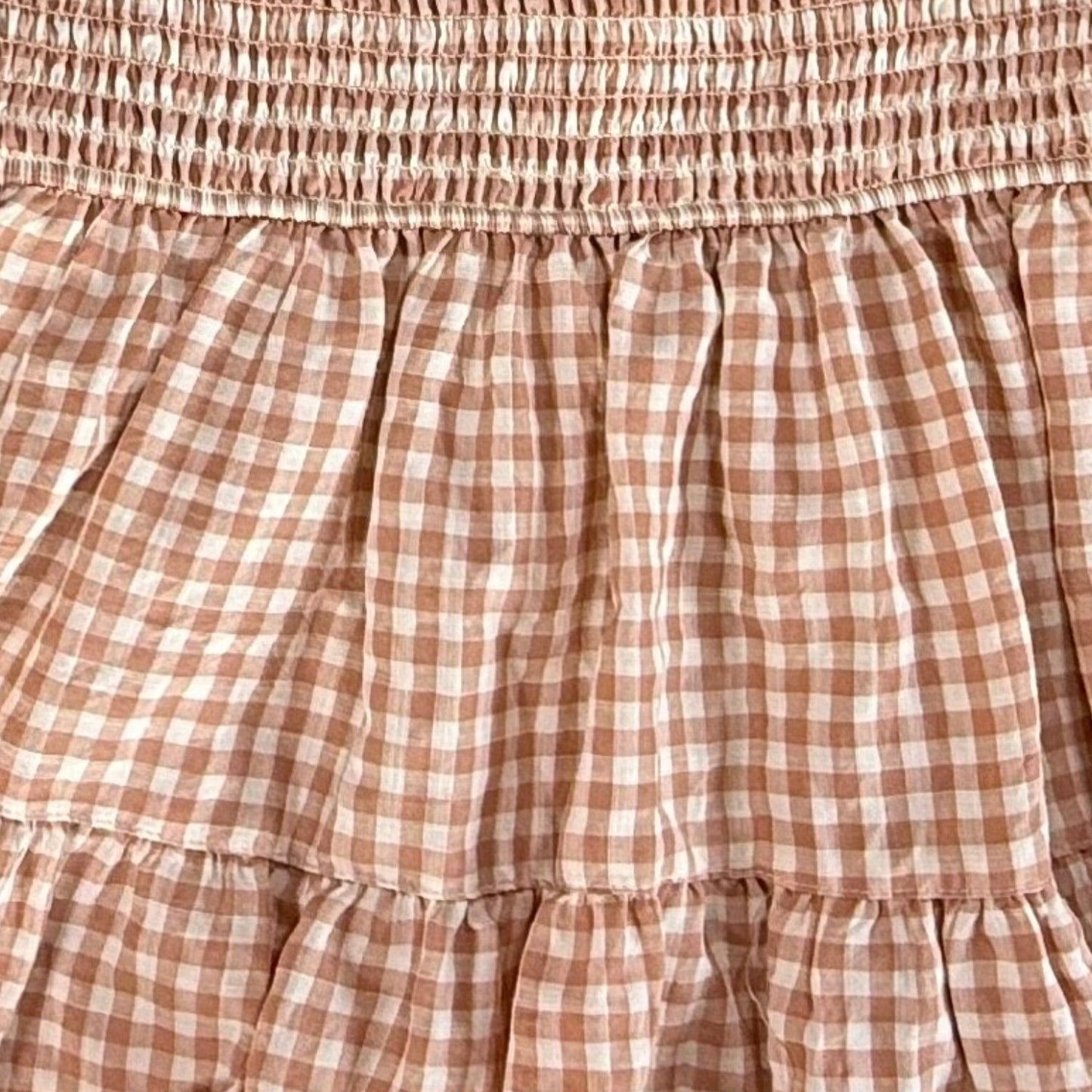 Close up of smocked bodice and gingham pattern on Rockin G blouse