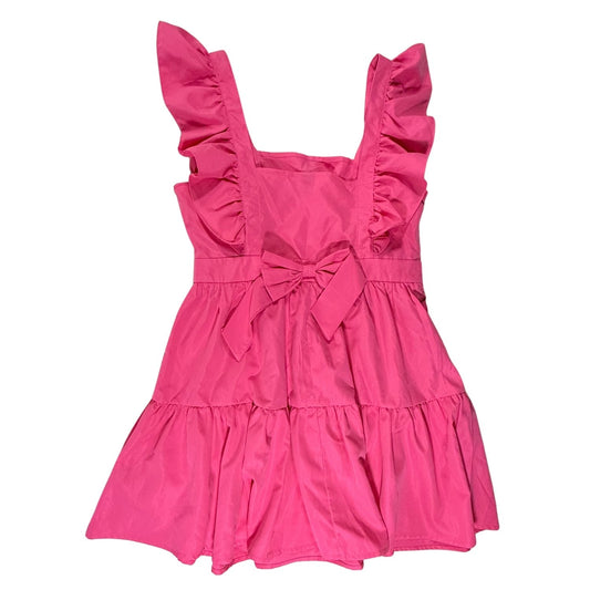 Back view of SHEIN bright pink mini dress with a decorative bow detail and tiered ruffle skirt.
