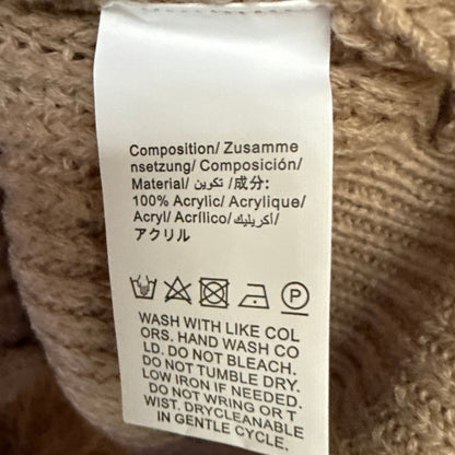 Material and care label on a beige SHEIN sweater showing 100% acrylic and hand wash cold instructions.
