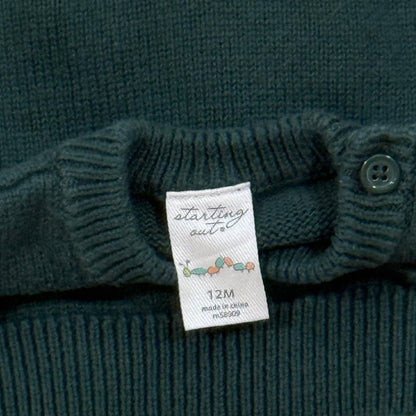 Starting Out brand and 12 month size label with shoulder button detail on baby sweater