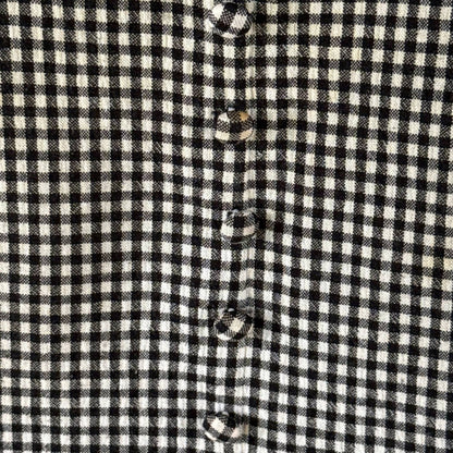 Close-up of black-and-white gingham fabric and matching fabric-covered decorative buttons on Stephanie Andrews dress.