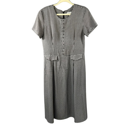 Front view of Stephanie Andrews women's size 8 black-and-white gingham midi dress with decorative buttons, pocket flaps, short sleeves, and pleated skirt.