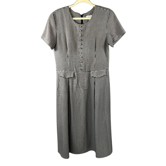 Front view of Stephanie Andrews women's size 8 black-and-white gingham midi dress with decorative buttons, pocket flaps, short sleeves, and pleated skirt.