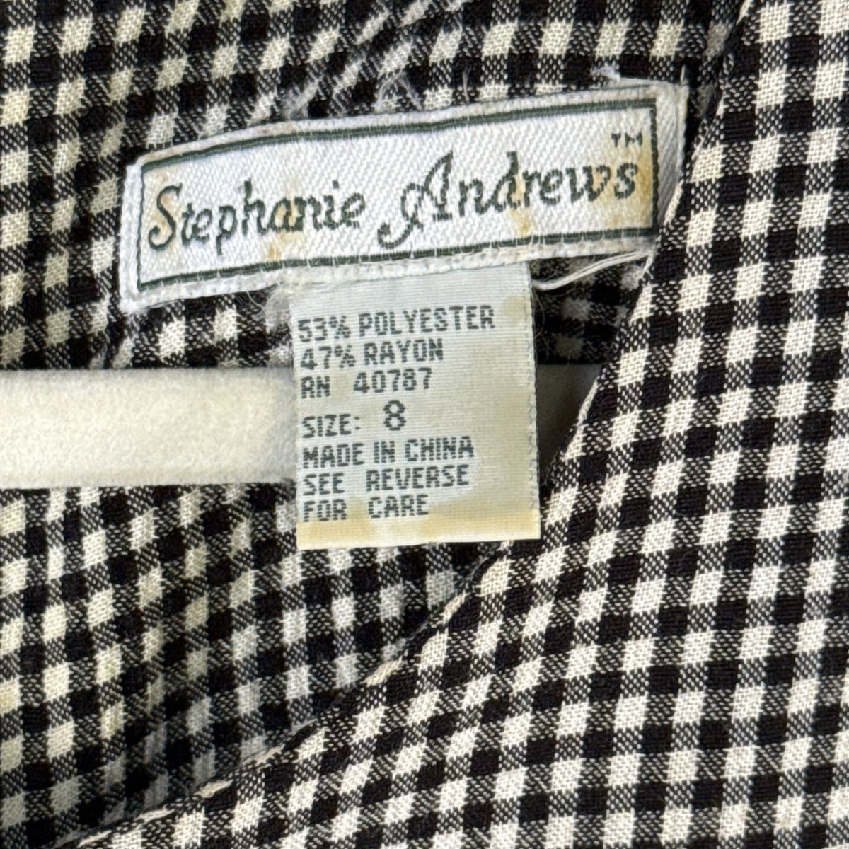 Stephanie Andrews women's size 8 dress label showing 53% polyester and 47% rayon fabric content.