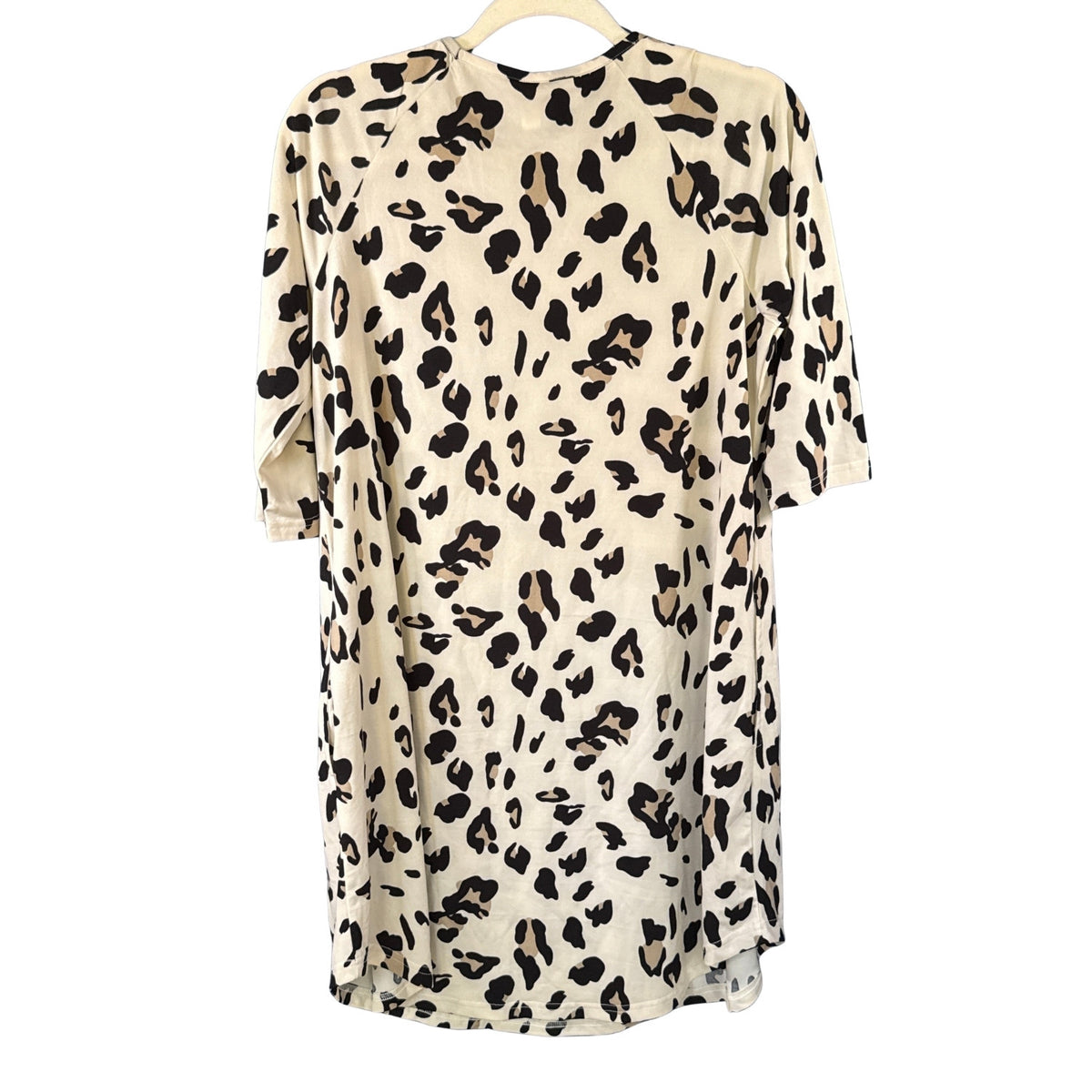 Back view of Tickled Teal cream leopard print dress showing relaxed silhouette, 3/4 sleeves, and curved hemline.