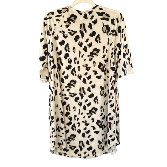 Back view of Tickled Teal cream leopard print dress showing relaxed silhouette, 3/4 sleeves, and curved hemline.