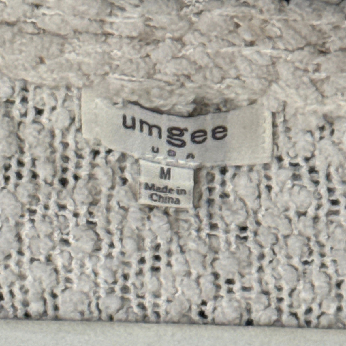 Umgee neckline tag showing size medium and made in China.