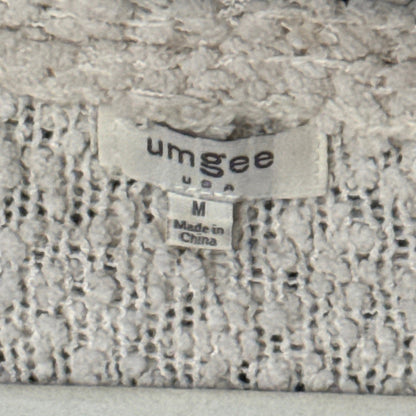 Umgee neckline tag showing size medium and made in China.