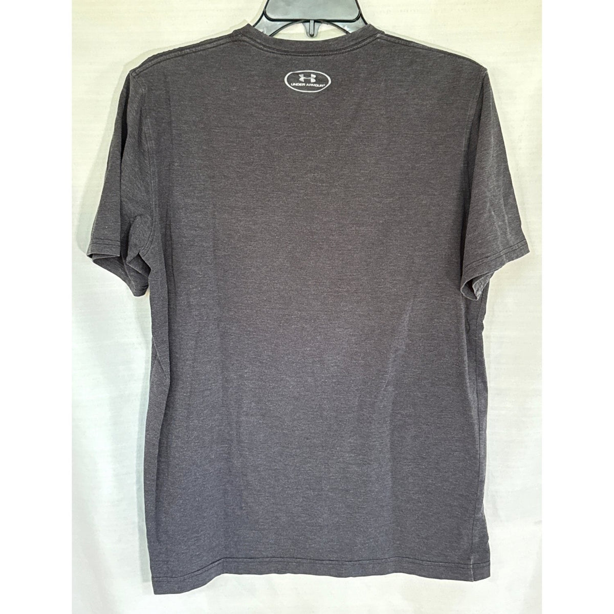 Back view of a faded black Under Armour short-sleeve T-shirt with a small logo below the neckline
