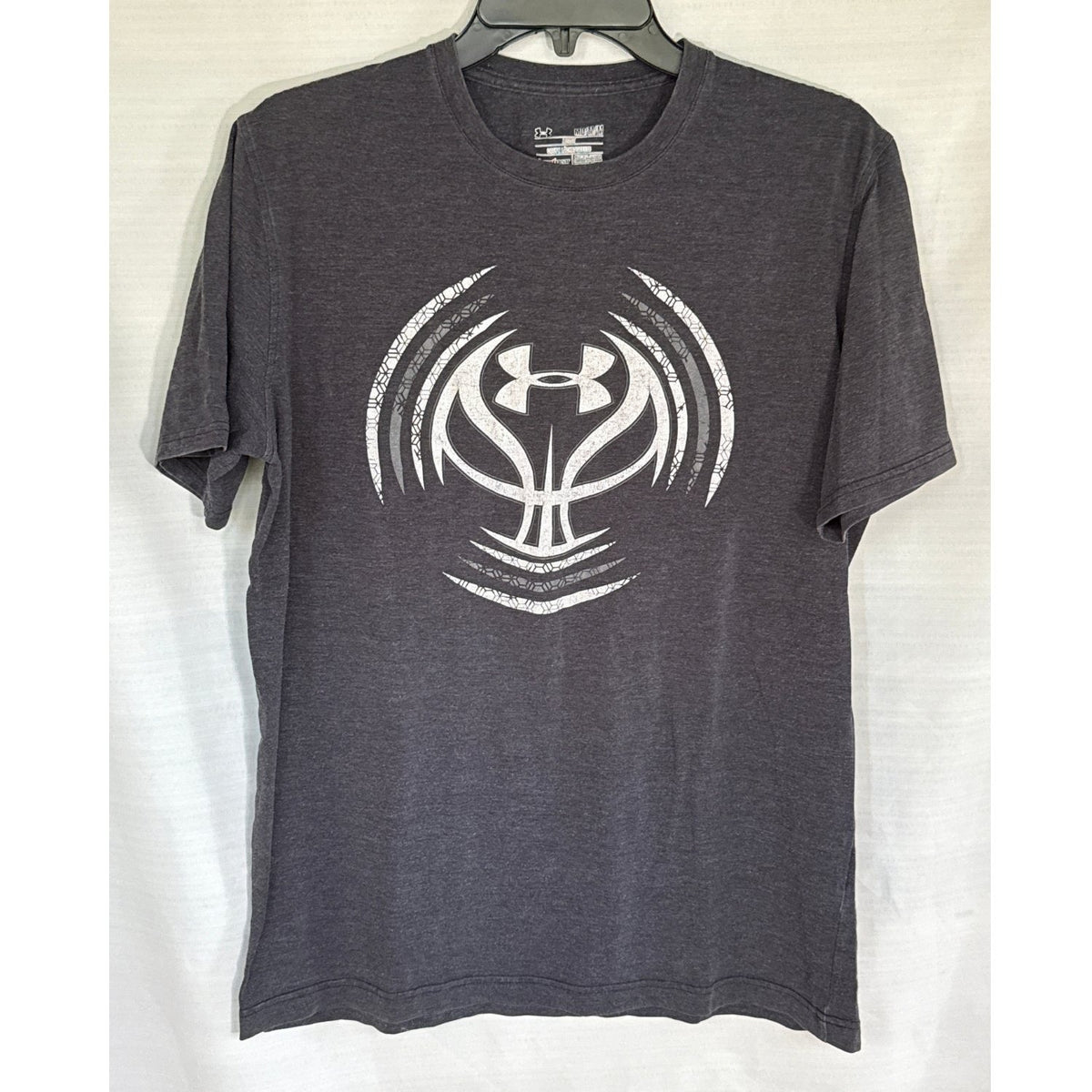 Front view of a faded black Under Armour T-shirt with a large white and gray basketball graphic