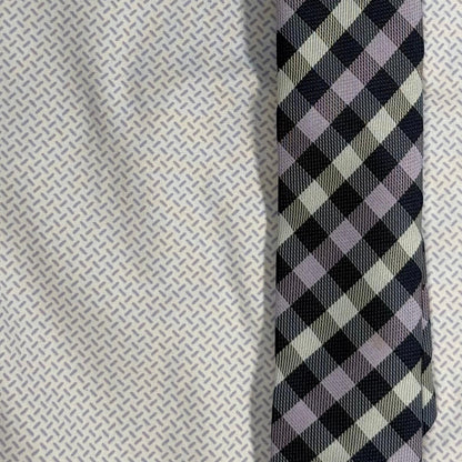 Close-up of the lavender geometric shirt print and coordinating plaid clip-on tie