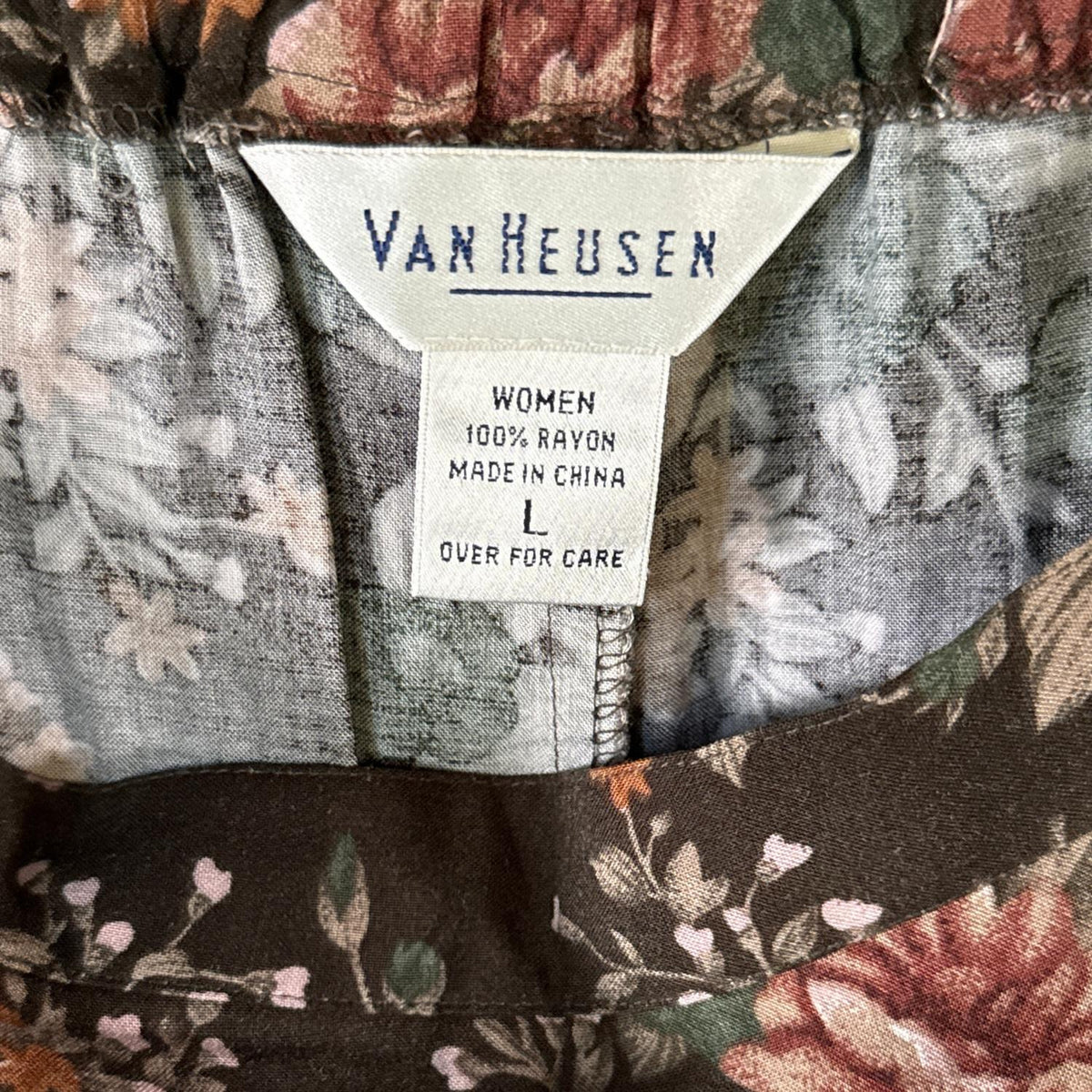 Van Heusen women's size large clothing label showing 100% rayon fabric content.
