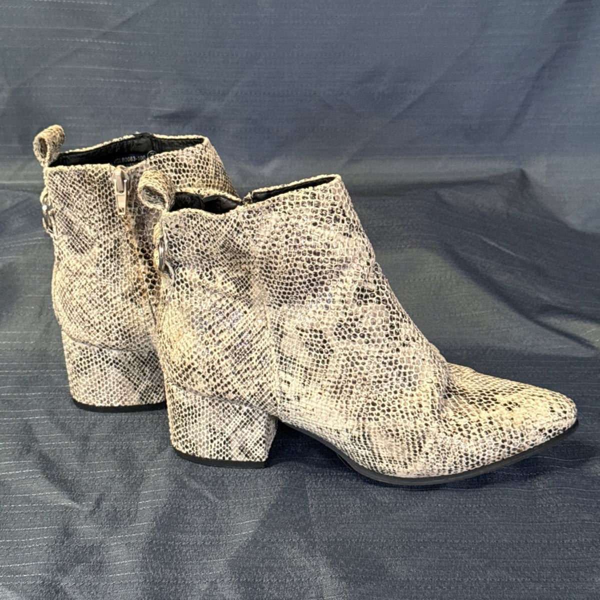 Angled side view of Very G textured snake-print ankle boots showing the block heels and pointed toes.
