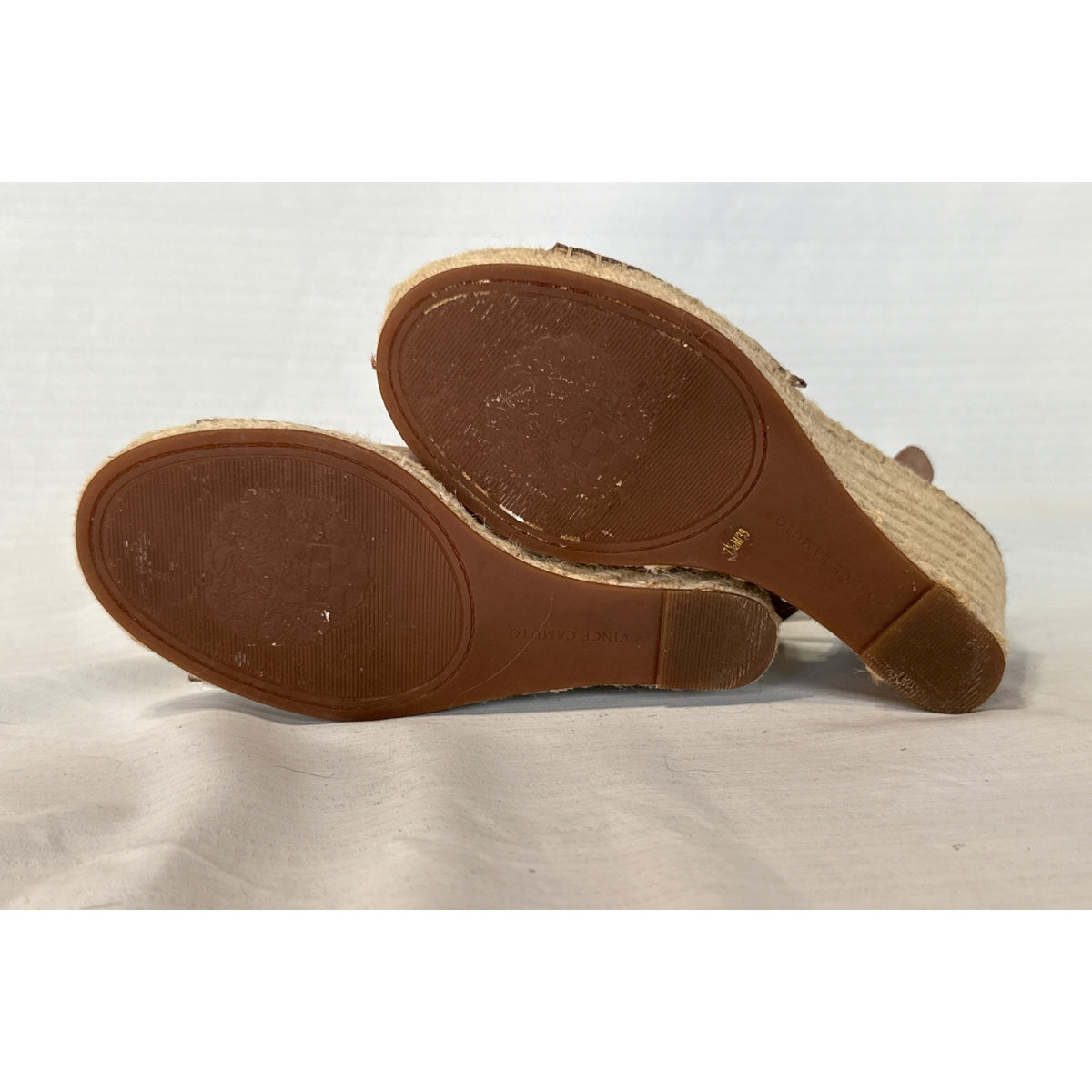 Bottom soles of Vince Camuto Leera taupe espadrille wedge sandals showing brown outsoles and signs of wear.
