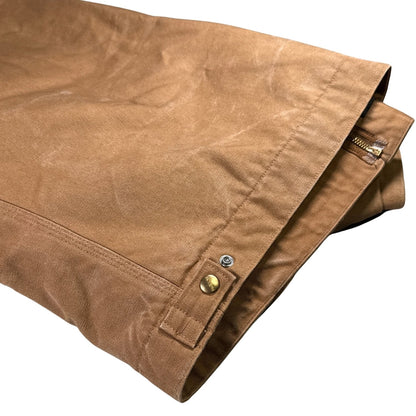 Close-up of hem seams and snap-adjustable waist tabs on vintage Carhartt Detroit Jacket