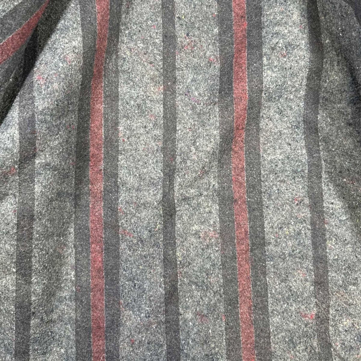 Close-up of gray, black and burgundy striped blanket lining inside vintage Carhartt jacket