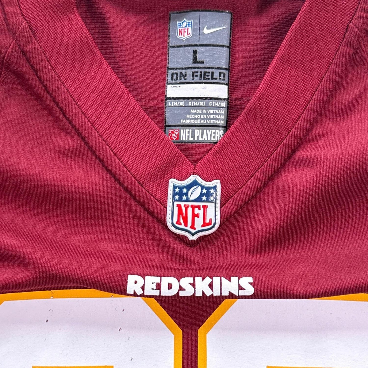 Nike NFL On Field youth Large 14–16 jersey tag and official NFL shield neckline