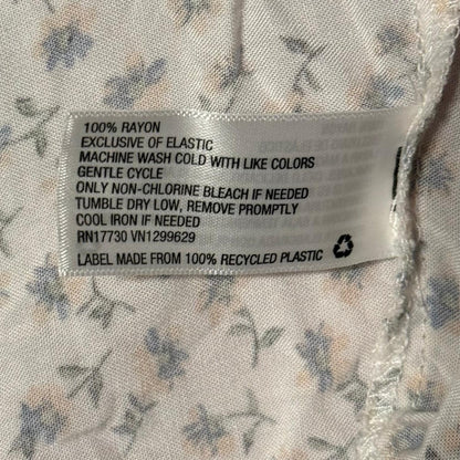 Material tag showing 100% rayon care instructions.