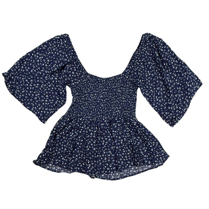 Back view of Willow + Root navy floral smocked peplum top with flutter sleeves and peplum hem.
