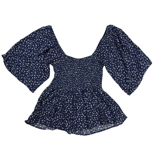 Back view of Willow + Root navy floral smocked peplum top with flutter sleeves and peplum hem.