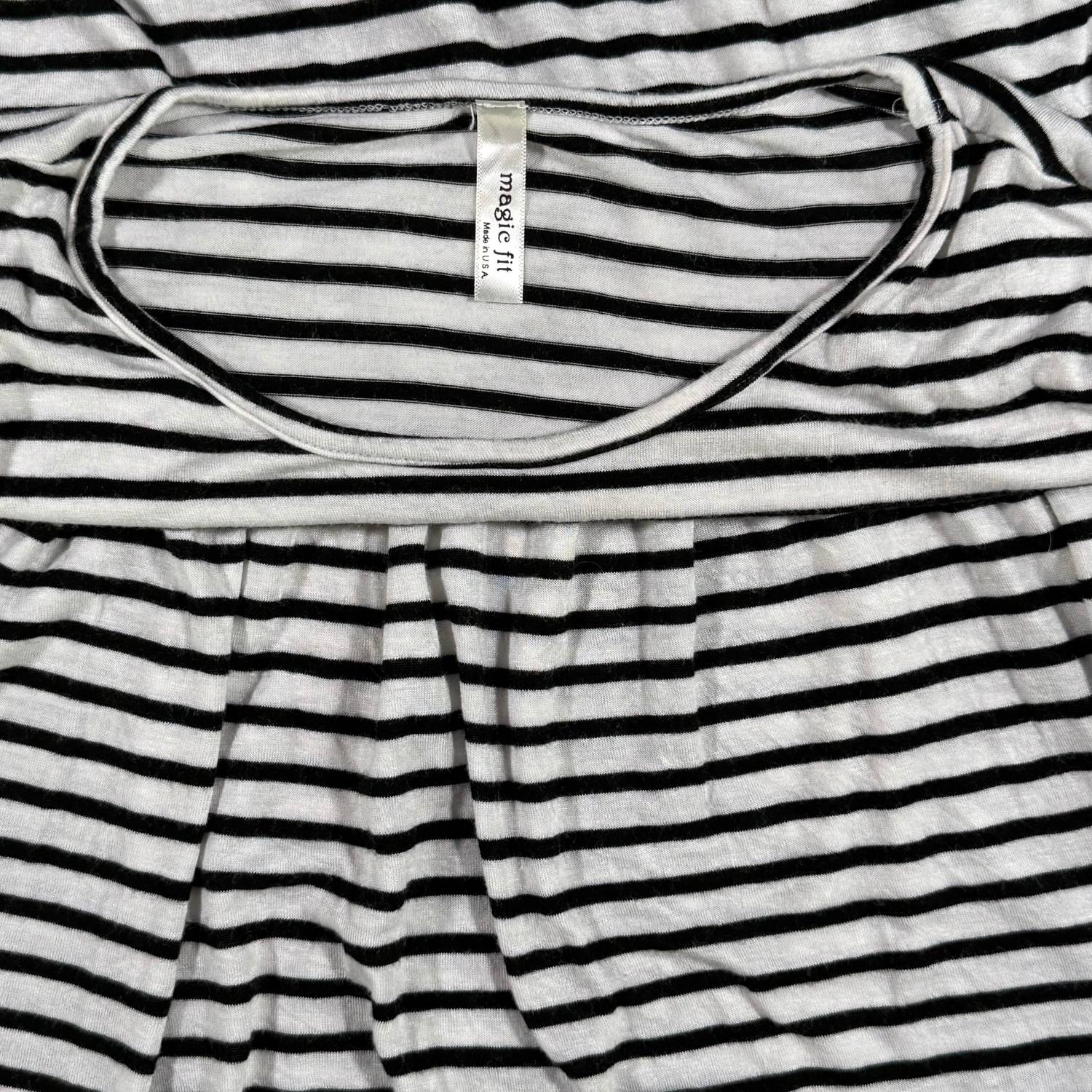 Magic Fit brand tag on a women's large black and white striped peplum top.