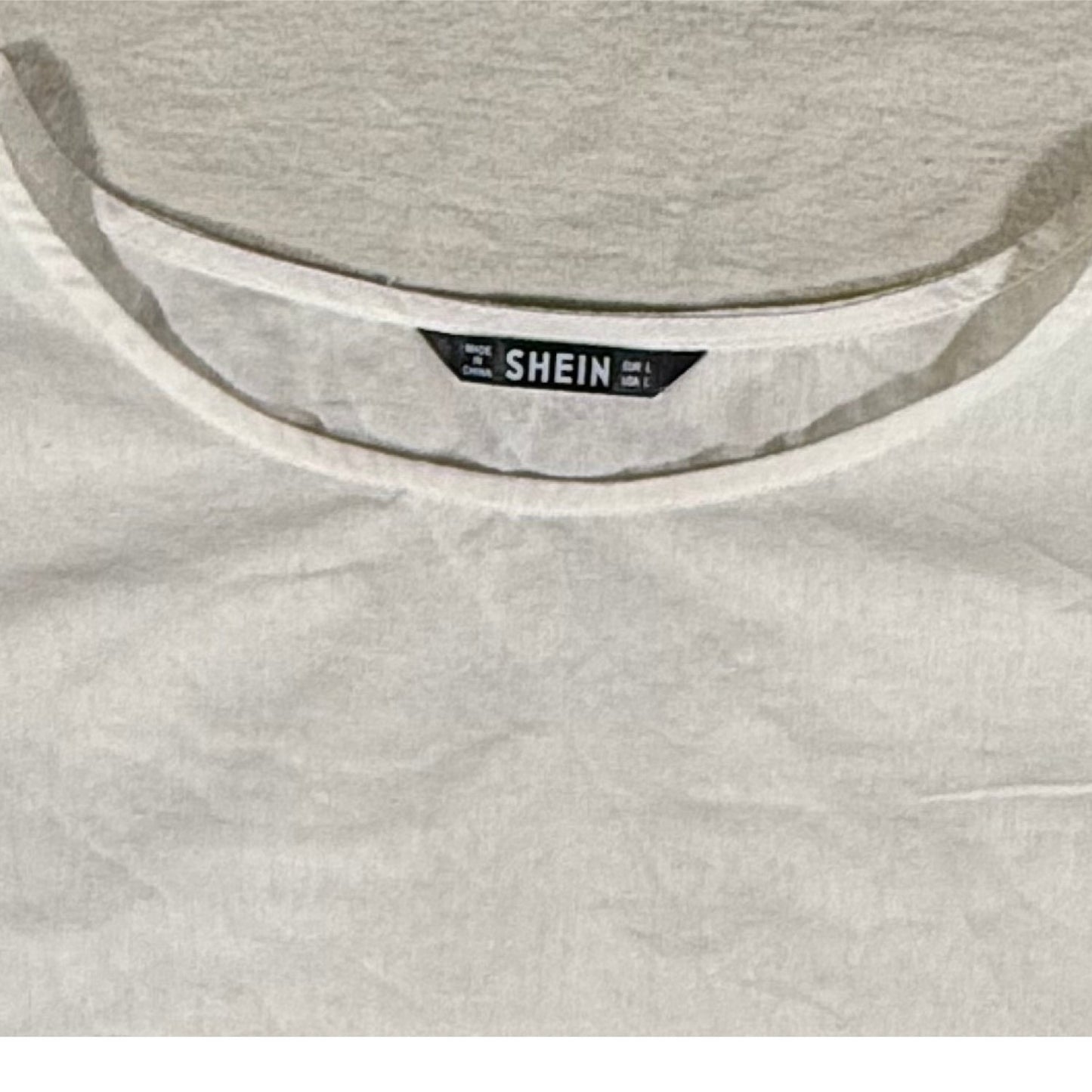 SHEIN brand tag on a women's large cream cotton top.