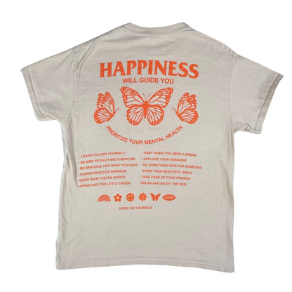 Back view of a women's medium Gildan tan graphic t-shirt with orange butterflies and "Happiness Will Guide You" design.