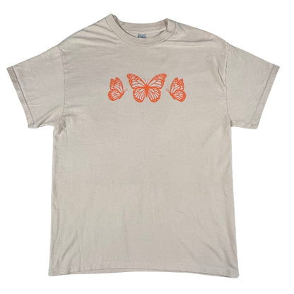 Front view of a women's medium Gildan tan graphic t-shirt featuring orange butterfly artwork.
