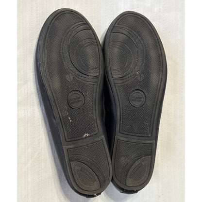Bottom view of Wonder Nation girls’ black ballet flats showing textured soles, size 1 markings, and light wear.
