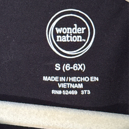 Wonder Nation girls clothing label showing size Small 6–6X inside black T-shirt.