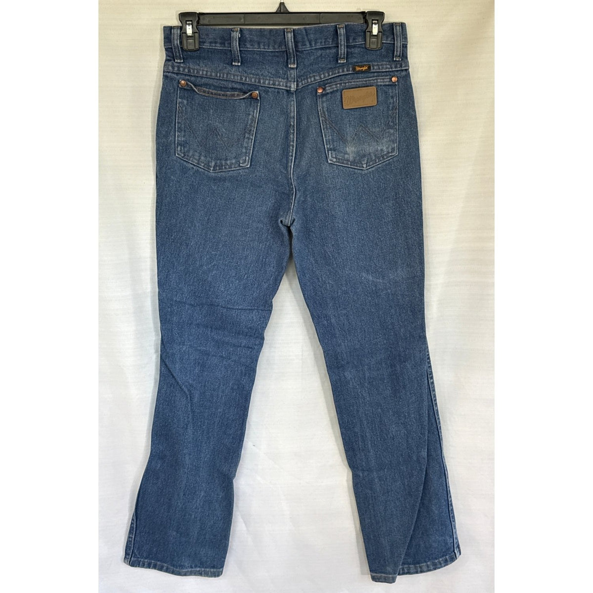Back view of blue Wrangler men’s jeans with W-stitched pockets and a Wrangler patch