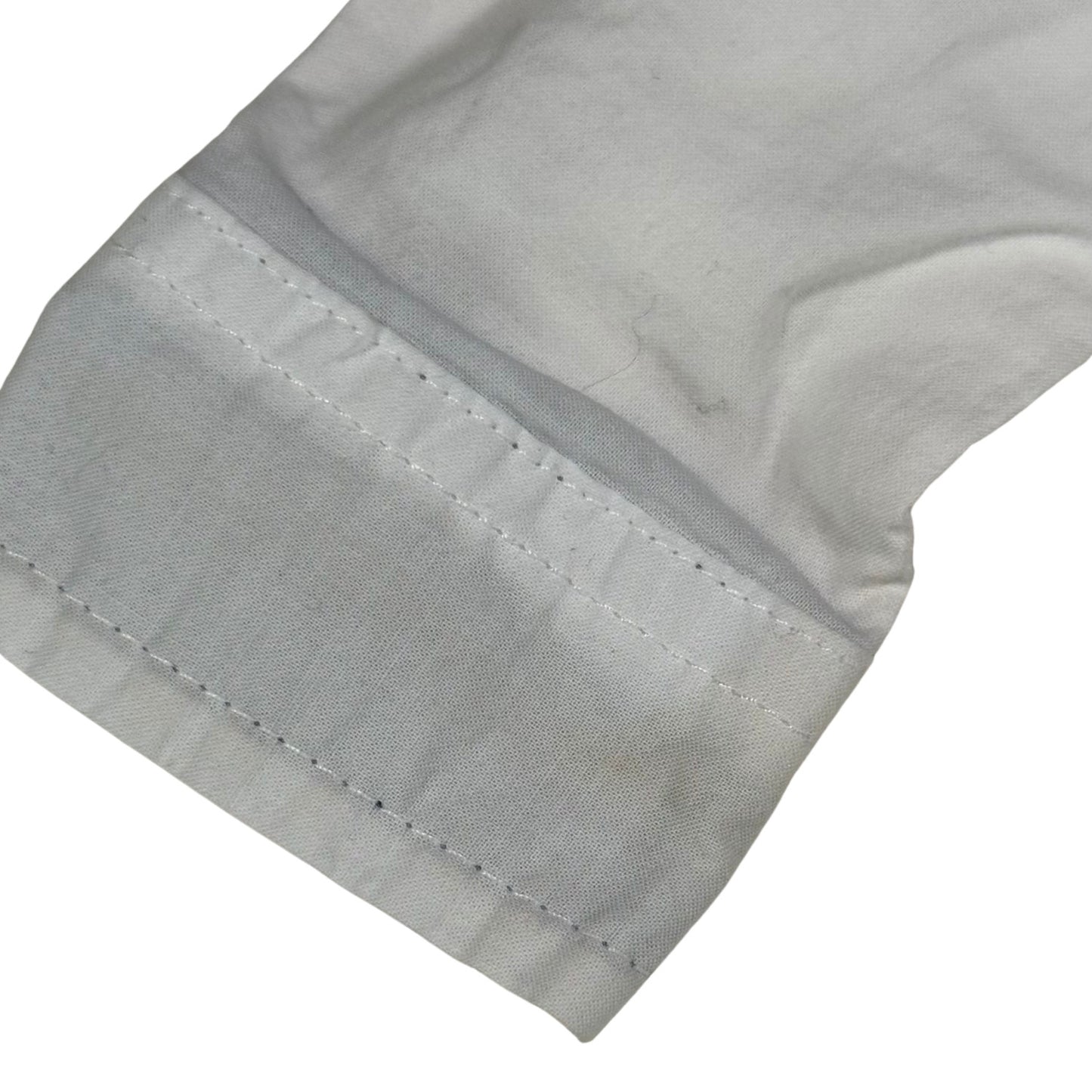 Minor stain on wrist of white baby dress onesie