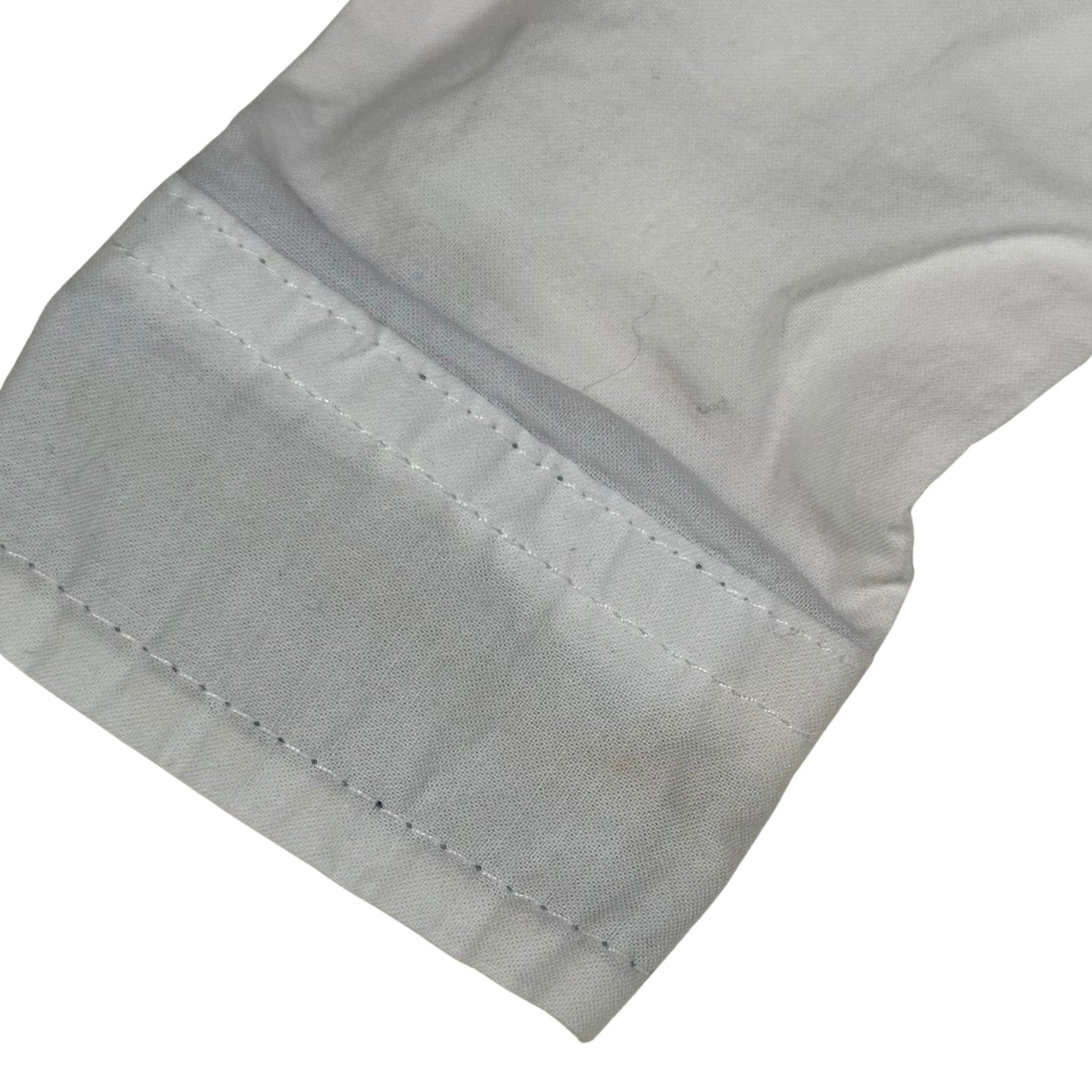 Minor stain on wrist of white baby dress onesie