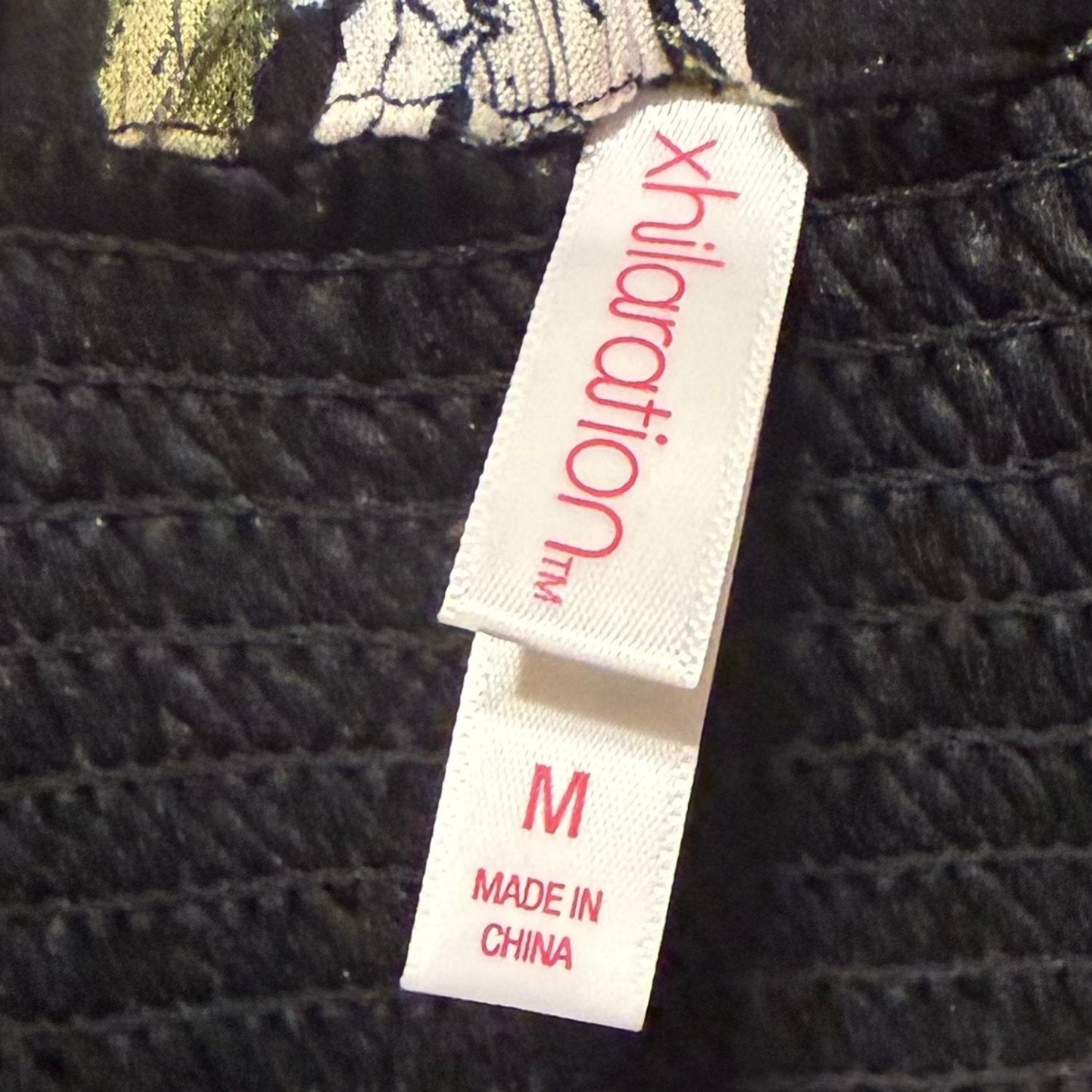 Xhilaration clothing label showing juniors size medium.