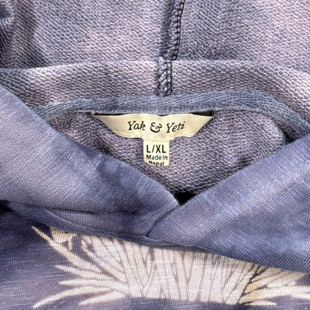 Yak & Yeti L/XL Made in Nepal label inside blue tie-dye mushroom hoodie