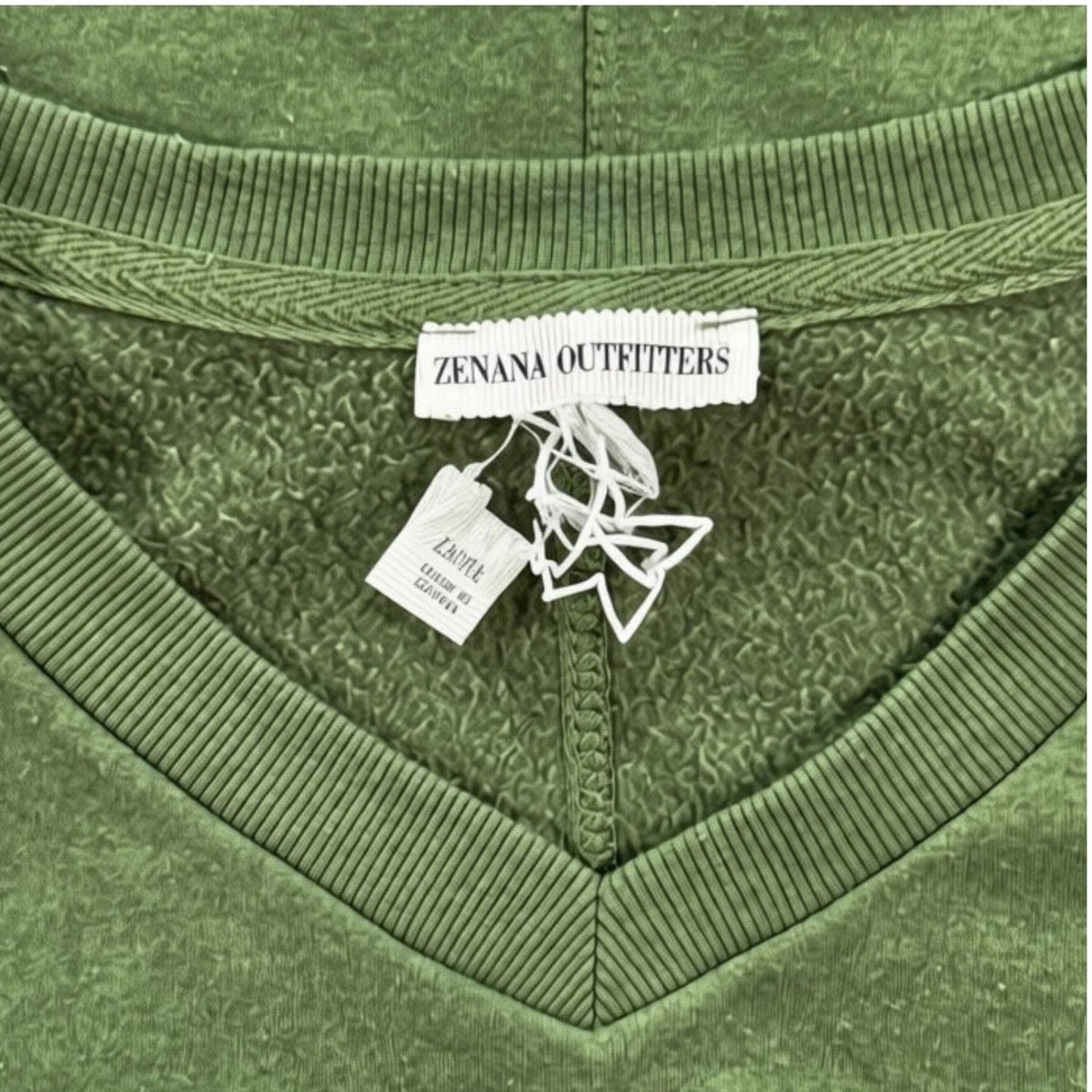 Zenana Outfitters brand label and V-neck trim on olive green sweatshirt